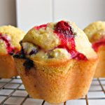 Glazed Cranberry Corn Muffins - Make your corn muffin recipe sweeter, softer, and prettier for the holidays with cranberries! These cranberry corn muffins are drizzled in a sweet glaze.
