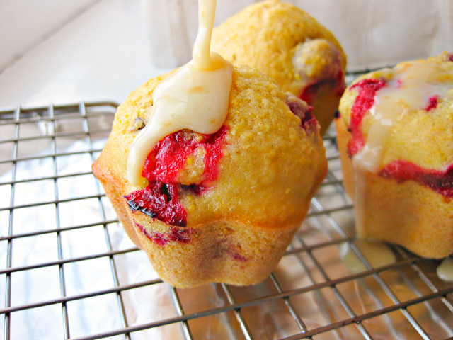 Glazed Cranberry Corn Muffins - Make your corn muffin recipe sweeter, softer, and prettier for the holidays with cranberries! These cranberry corn muffins are drizzled in a sweet glaze. 
