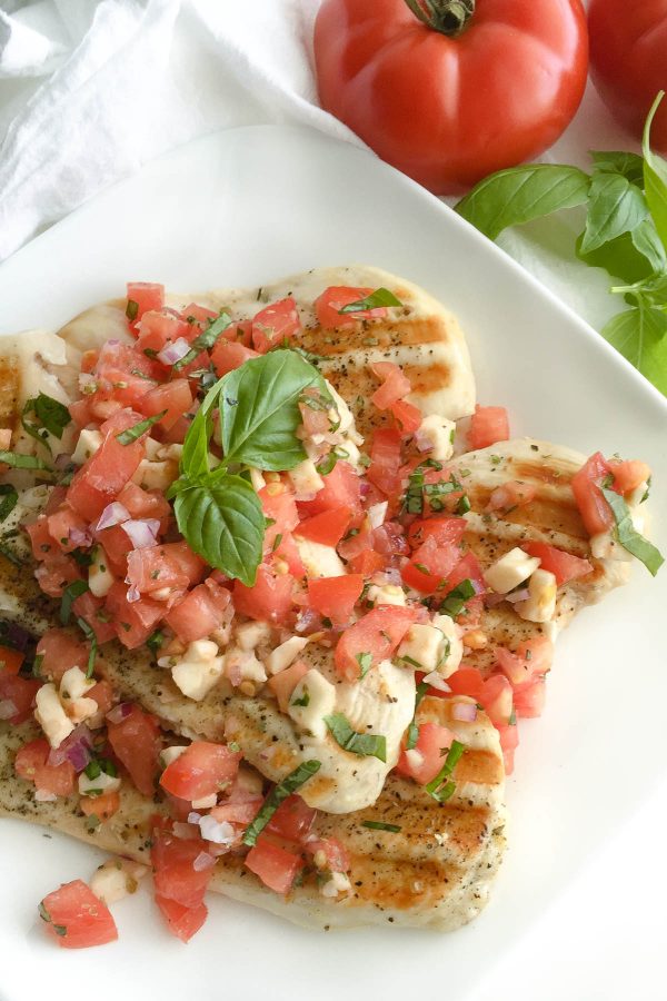Grilled Chicken with Bruschetta Topping - Forget basic grilled chicken recipes and add flavor with this quick and easy tomato mozzarella bruschetta topping! 