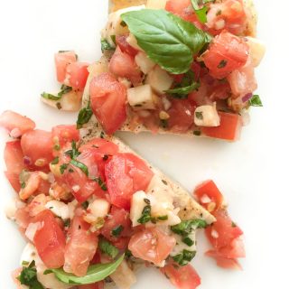 Grilled Chicken with Bruschetta Topping - Forget basic grilled chicken recipes and add flavor with this quick and easy tomato mozzarella bruschetta topping!