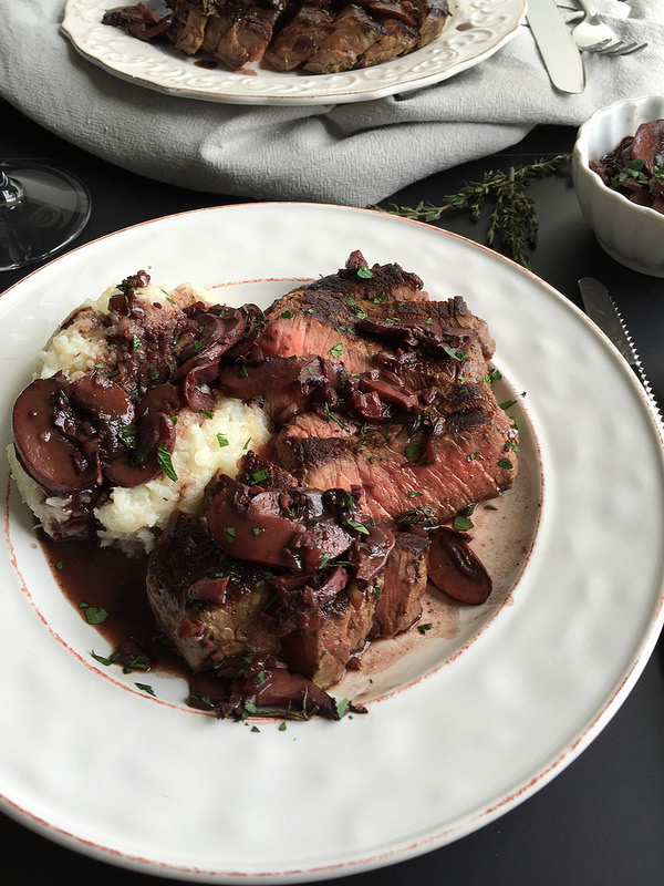 Beef with Red Wine Mushroom Sauce - an easy to prepare beef recipe with restaurant quality appeal and flavor! Just sear tenderloin steaks and saute a thyme-infused mushroom sauce using a dry red wine like cabernet sauvignon