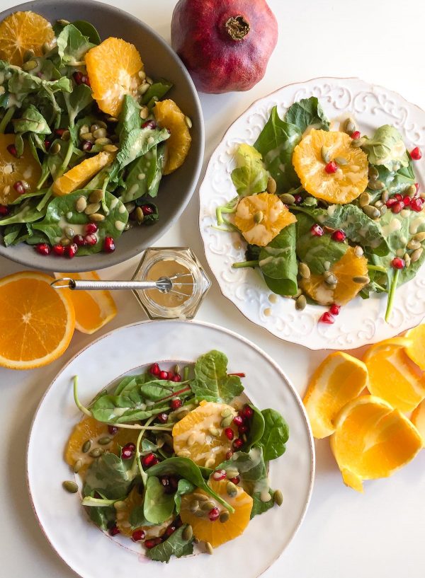 Baby Kale Salad with Orange, Pomegranate, and Maple Tahini Dressing - This gorgeous mix of fall fruits and veggies packs a powerful nutritious punch!