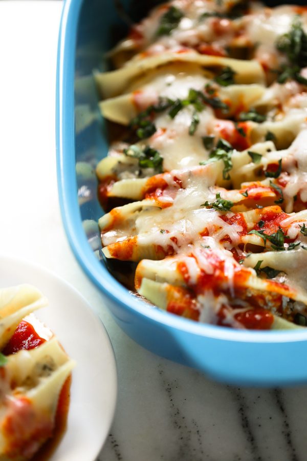 Easy (and Light!) Stuffed Shells Recipe with a secret ingredient to make them low calorie and high protein, too! These are make ahead and freezer friendly!