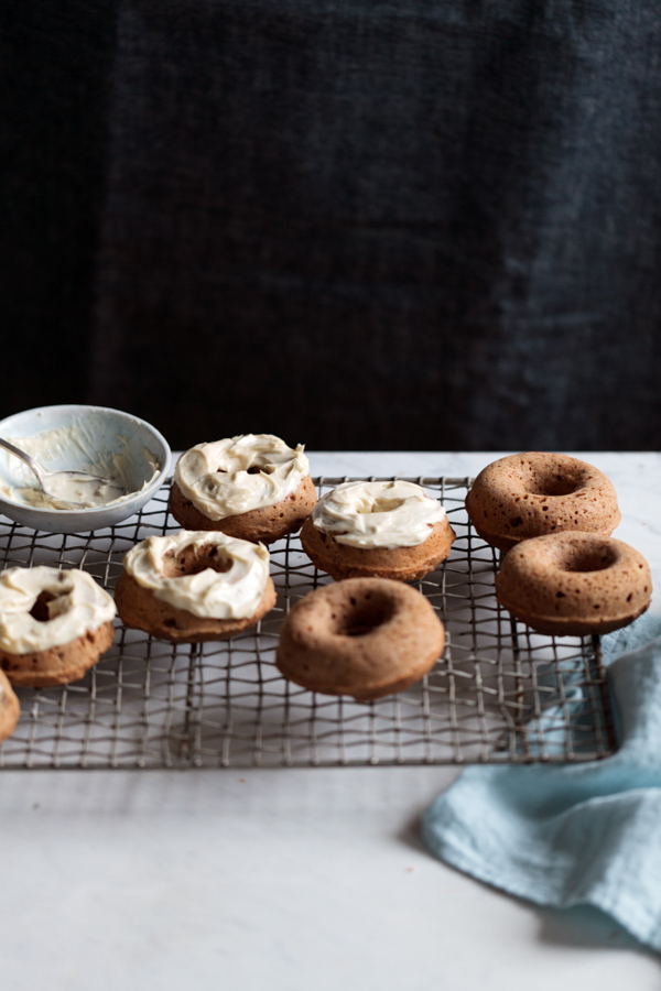 Eating in the Middle - A Mostly Wholesome Cookbook by Andie Mitchell - low calorie / healthy recipes with big flavor like these baked banana bread doughnuts with cream cheese glaze