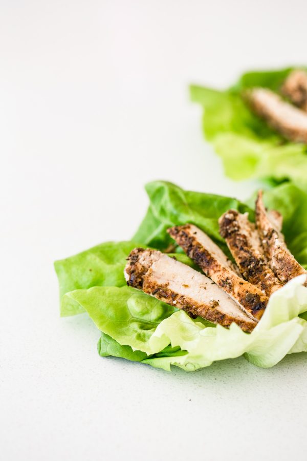 Jerk Chicken Lettuce Wraps Recipe - make a zesty, bold jerk marinade with lime, allspice, thyme, brown sugar, and a few other key ingredients and give your chicken SO MUCH flavor! These wraps get drizzled in a fresh, sweet orange vinaigrette and topped with creamy avocado, crunchy carrots, and red onion! Great for lunch, dinner, and easy to make ahead so be sure to add them to your meal prep roster! Low carb recipes
