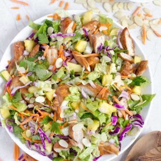 Hawaiian Salad with Pineapple Chicken - This healthy, tropical salad has ginger-soy marinated chicken, pineapple chunks, romaine lettuce, red cabbage, carrots, almonds, and a soy sauce and sesame vinaigrette!