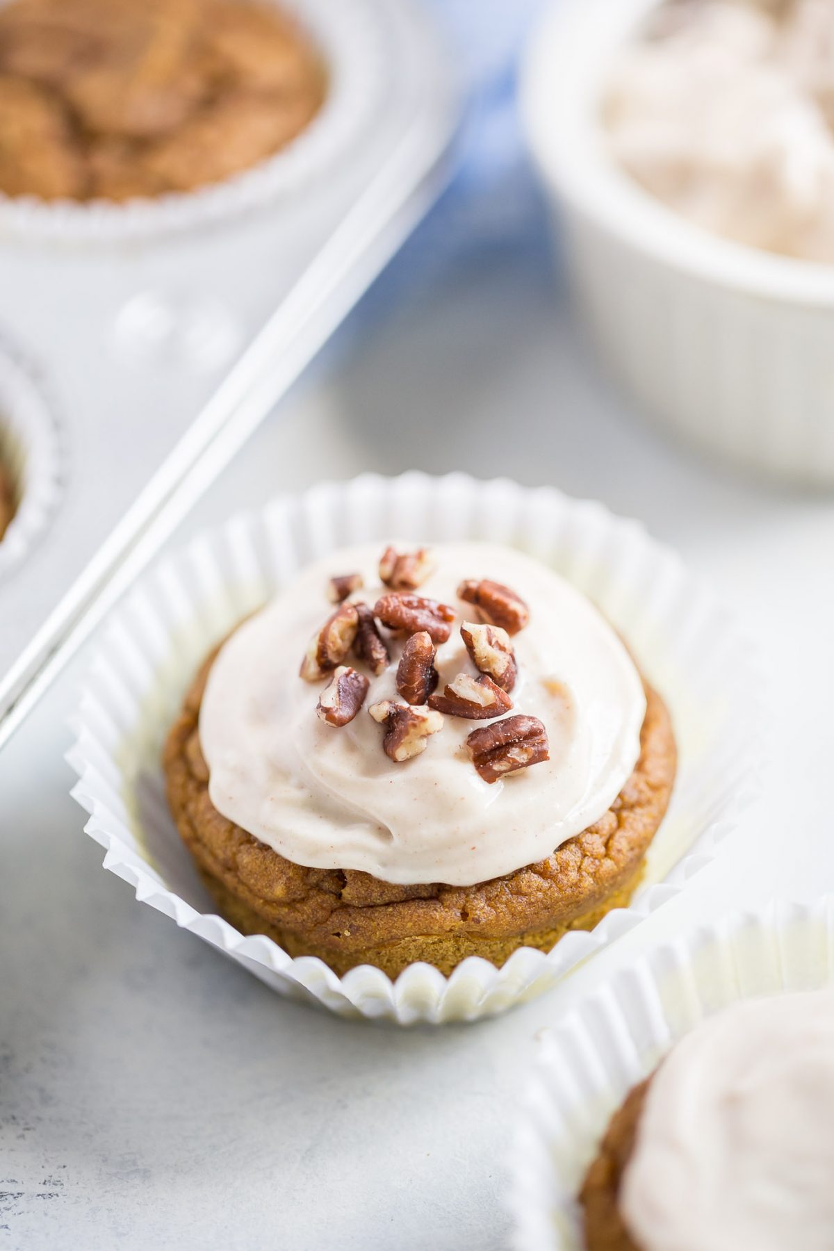 Naturally Sweetened Pumpkin Cupcakes with Maple Cream Cheese Frosting - made with no refined sugar! These are naturally sweetened with medjool date paste!